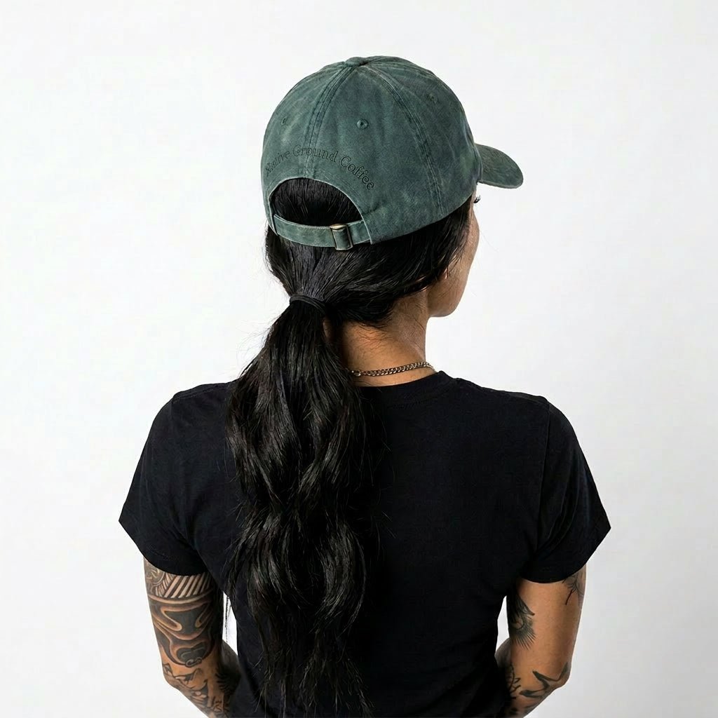 Person wearing a green cap and black t-shirt on a white background
